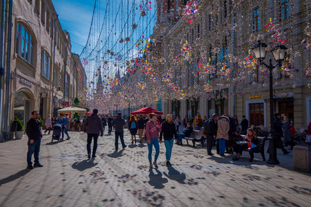 MOSCOW, RUSSIA- APRIL, 24, 2018: People in a festive Christmas lights on Nikolskaya street with many...