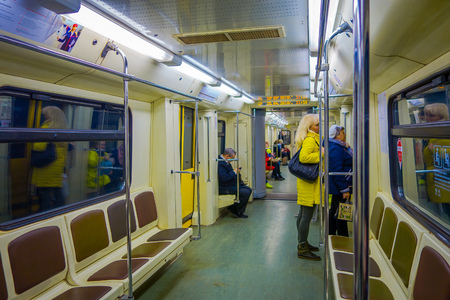 MOSCOW, RUSSIA- APRIL, 29, 2018: People inside of metro, perspective view to Contemporary spacious interior and comfortable seats of modern train moving fast inside urban metro tunnelのeditorial素材