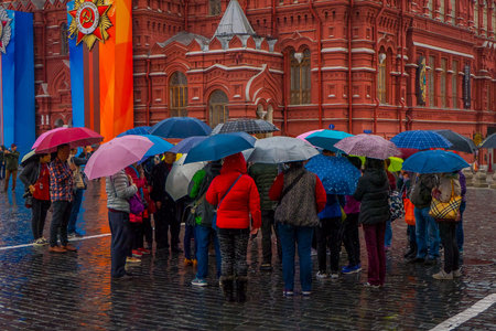 MOSCOS, RUSSIA- APRIL, 24, 2018: Outdoor view of unidentified people with umbrellas protecting from...