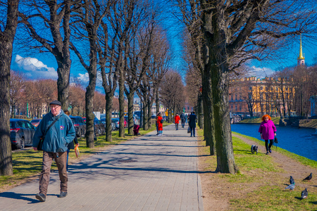 ST. PETERSBURG, RUSSIA, 02 MAY 2018: Outdoor view of unidentified people in a park having a good time with their relatives in the border of the Moika river in a sunny day in St Petersburgのeditorial素材