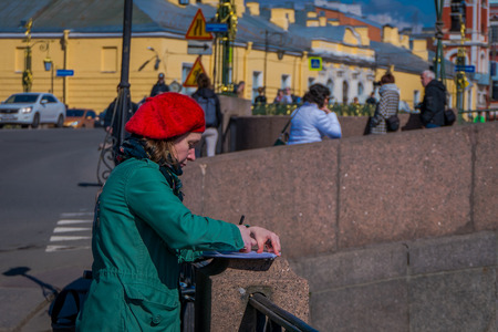 ST. PETERSBURG, RUSSIA, 02 MAY 2018: Close up of blonde woman wearing a black sunglasses ans black jacket, walking in the streets of in St. Petersburgのeditorial素材