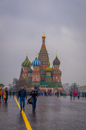 MOSCOW, RUSSIA- APRIL, 29, 2018: Outdoor view of unidentified people walking on Red Square with a gorgeous view of Cathedral of Vasily the Blessed in a rainny day in the city of Moscowのeditorial素材