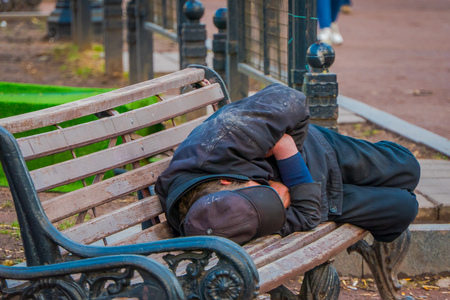 MOSCOW, RUSSIA- APRIL, 29, 2018: Outdoor view of unidentified homeless man sleeping in a public chair in a park in Moscowのeditorial素材