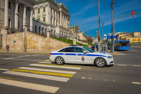 MOSCOW, RUSSIA- APRIL, 24, 2018: Outdoor view of unidentified man inside of a police car driving on Red Square in a sunny day, in Moscow in Russiaのeditorial素材