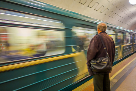 MOSCOW, RUSSIA- APRIL, 24, 2018: Unidentified man waiting a train in tube station on which rides express with passengers, metro, Moscowのeditorial素材