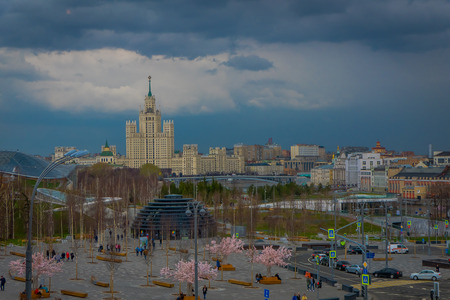 MOSCOW, RUSSIA- APRIL, 24, 2018: Above view of arbat street with unidentified tourists walking close to pink trees in the boulevar and International Business Center behind in Moscowのeditorial素材