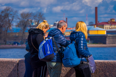 ST. PETERSBURG, RUSSIA, 01 MAY 2018: Outdoor view of russian familiy enjoying the view with blurred background of the city in the horizont in St. Petersburgのeditorial素材