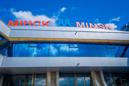 MINSK, BELARUS - MAY 01 2018: Outdoor below view of Zhukovsky International airport, with a reflection in the glass, in a gorgeous blue sky in sunny day located in Minskのeditorial素材