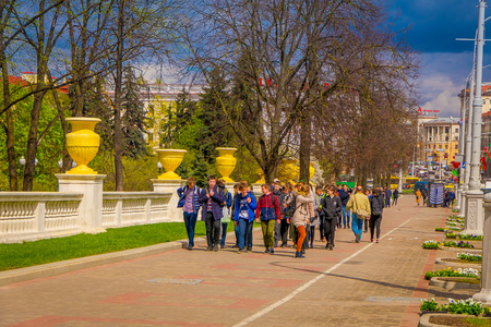 MINSK, BELARUS - MAY 01, 2018: Outdoor view of teenagers walking in the sidewalk in dowtown of the city, close to the Victory Park in Minskのeditorial素材