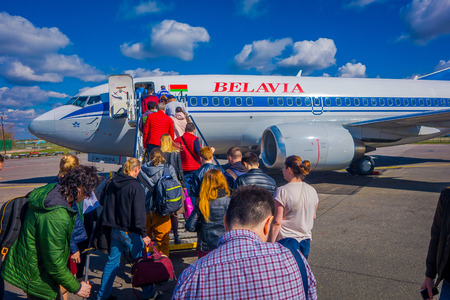 MINSK, BELARUS - MAY 01 2018: Outdoor view of unidentiifed people boarding the tupolev Tu-154 EW-85741 Belavia Airlines, in the Minsk National Airport during a gorgeous sunny day in Minskのeditorial素材