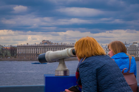 ST. PETERSBURG, RUSSIA, 17 MAY 2018: Outdoor view of unidentified people using a binoculars viewer...