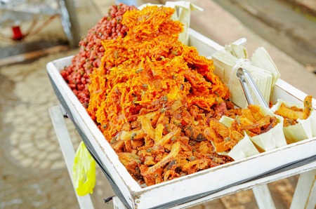 Close up of cocada, a traditional coconut dessert sold usually on the streets, made of grated coconut and brown sugar, which gives it the dark colorの写真素材