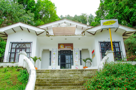 POPAYAN, COLOMBIA - FEBRUARY 06, 2018: Outdoor view of informative sign at the enter of white buildig giving information of service of employment in Popayan townのeditorial素材