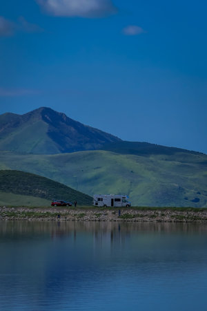 Idaho, USA, May 23, 2018: Outdoor view of a trailer in the riverside of the lake under a deep blue...