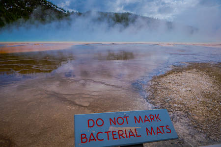 YELLOWSTONE, MONTANA, USA MAY 24, 2018: Close up of informative sign written over a wooden structure at Grand Prismatic Spring, Midway Geyser Basin, Yellowstone National Parkのeditorial素材
