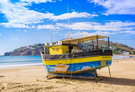 San Juan del Sur, Nicaragua - May 11, 2018: Outdoor view of yellow boat on the beach of San Juan Del sur on the ocean coast in Nicaragua with beautiful beachesのeditorial素材