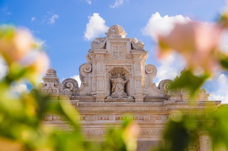 Ciudad de Guatemala, Guatemala, April, 25, 2018: Close up of selective focus of blurred flowers with old building with carved structures behind in the city of Antigua in a gorgeous sunny dayのeditorial素材