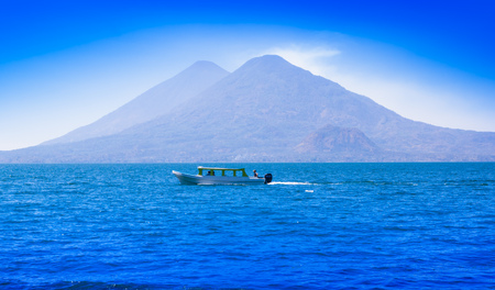 Beautiful outdoor view of small boats in Atitlan Lake is the deepest lake in all of Central America with a maximum depth of about 340 meters, with volcano in Background in Guatemala.の写真素材