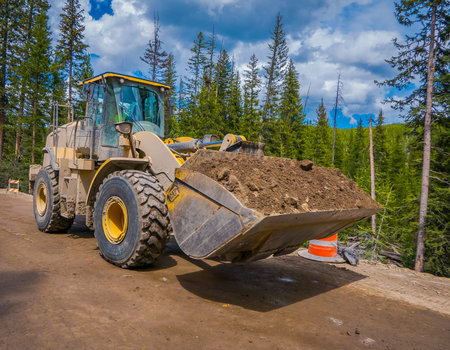 YELLOWSTONE NATIONAL PARK, WYOMING, USA - JUNE 07, 2018: Outdoor view of truck removing soil in a...