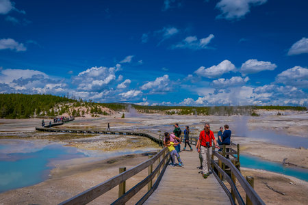 YELLOWSTONE, MONTANA, USA JUNE 02, 2018: Unidentified people taking pictures and enjoying the Pools of colorfully colored water dot of the Norris Geyser Basin in Yellowstone National Parkのeditorial素材