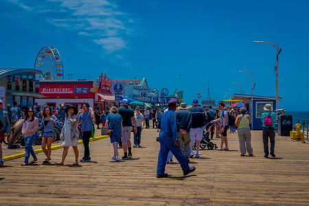 Los Angeles, California, USA, JUNE, 15, 2018: Outdoor view of people walking at the pier of Santa Monica Pier, at the end of Route 66. The amusement park is a world famous tourist attractionのeditorial素材