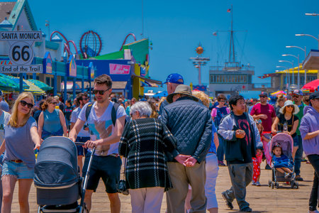 Los Angeles, California, USA, JUNE, 15, 2018: Santa Monica Pier, Picture with people walking at the pier with the end of Route 66. The amusement park is a world famous tourist attractionのeditorial素材