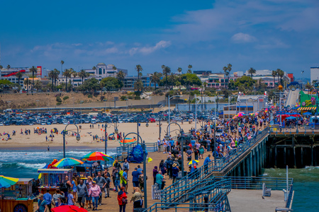 Los Angeles, California, USA, JUNE, 15, 2018: Crowd of unidentified tourists walking in the wooden pier by the Santa Monica, amusement park in Californiaのeditorial素材