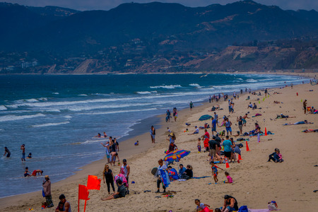 Los Angeles, California, USA, JUNE, 15, 2018: Outdoor view of unidentified people visit the beach and enjoying and walking in the sand in Santa Monica, Californiaのeditorial素材