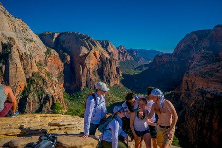 ZION, UTAH, USA - JUNE 14, 2018: Outdoor beautiful view of young hikers looking at view in Zion National park. People living healthy active lifestyle in Zion Canyon, Utahのeditorial素材