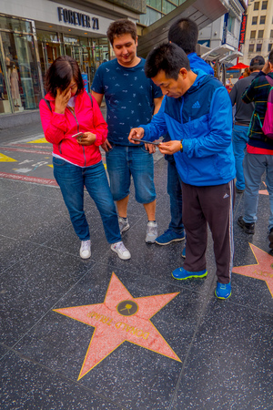 Los Angeles, California, USA, JUNE, 15, 2018: Outdoor view of family taking a picture of a Donald Trump fame star in walk of fame in Los Angeles. Hollywood Walk of Fame features more than 2,500 starsのeditorial素材
