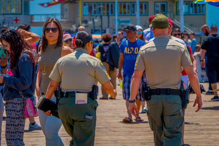 Los Angeles, California, USA, JUNE, 15, 2018: Outdoor view od people and police walking at the pier with the end of Route 66 in Santa Monica. The amusement park is a world famous tourist attractionのeditorial素材
