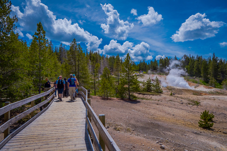 YELLOWSTONE, MONTANA, USA JUNE 02, 2018: Unidentified people taking pictures and enjoying the Pools of colorfully colored water dot of the Norris Geyser Basin in Yellowstone National Parkのeditorial素材
