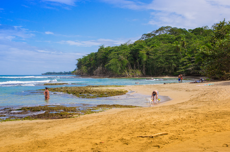 PUERTO VIEJO, COSTA RICA, JUNE, 26, 2018: Outdoor view of unidentified people swimming and enjoying the sunny day and blue waterin to Puerto Viejo beach on the caribbean coastのeditorial素材
