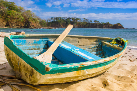 PLAYA MONTEZUMA, COSTA RICA, JUNE, 28, 2018: Outdoor view of small boat in the shore in Playa Montezuma during gorgeous sunny day with blue sky and blue waterのeditorial素材