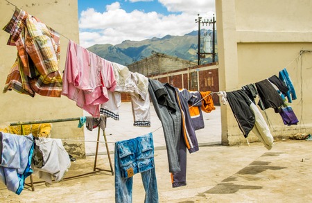 QUITO, ECUADOR, AUGUST 21, 2018: Colorful clothes are drying in the wind hanging in lines in sunny dayのeditorial素材