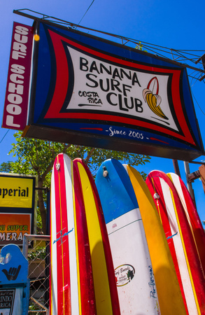 Samara, Costa Rica, June, 26, 2018: Close up of surfboard standing in front of a rental shop in a gorgeous sunny day and with blue sky in relaxing tamarindo beachのeditorial素材