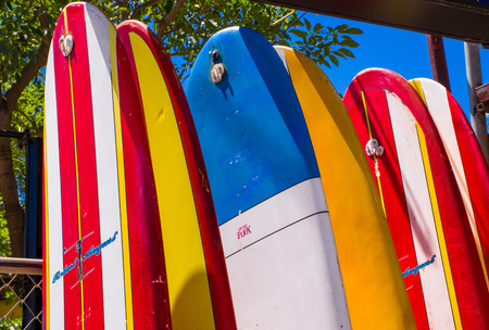 Tamarindo, Costa Rica, June, 26, 2018: Close up of surfboard standing in front of a rental shop in a gorgeous sunny day and with blue sky in relaxing tamarindo beachのeditorial素材