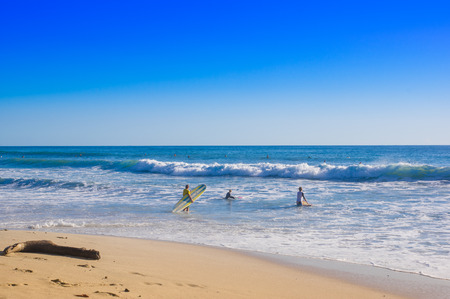 Santa Teresa, Costa Rica - June, 28, 2018: Outdoor view of surfers on the beach of Santa Teresa in a beautiful sunny day with blue sky and blue water in Costa Ricaのeditorial素材