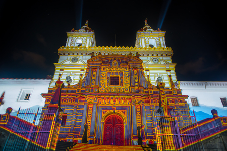QUITO, ECUADOR- AUGUST, 15, 2018: Crowd admiring the spectacle of lights projected on the facade of San francisco church, festival of light is an event that takes place every August in Quitoのeditorial素材