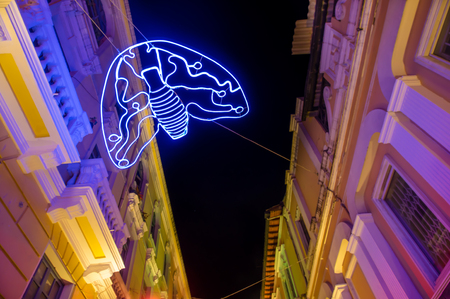 QUITO, ECUADOR- AUGUST, 15, 2018: Below view of illuminated figures in a tight street during a spectacle of festival of light takes place every August in Quitoのeditorial素材