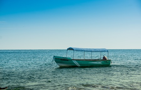 MANABI, ECUADOR, MAY, 29, 2018 Outdoor view of fishing boat in the ocean during a gorgeous sunny day in the beach of Cojimiesのeditorial素材