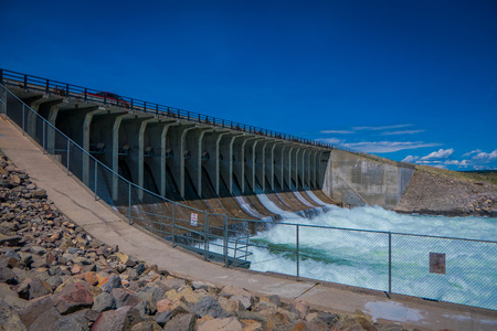 YELLOWSTONE, MONTANA, USA MAY 24, 2018: Outdoor view of water rushing through the spillway gates at the dam on Jackson Lake in Grand Teton National Parkのeditorial素材