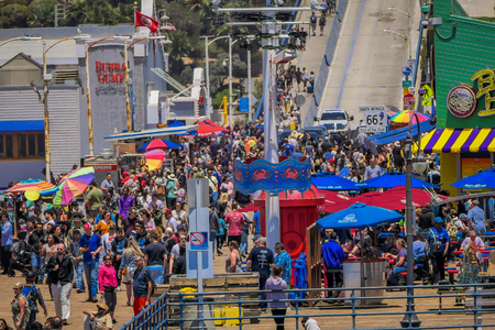Los Angeles, California, USA, JUNE, 15, 2018: Outdoor view of people walking at the pier of Santa Monica Pier, at the end of Route 66. The amusement park is a world famous tourist attractionのeditorial素材