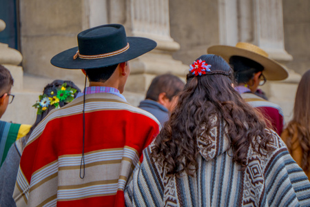 VALPARAISO, CHILE - SEPTEMBER, 15, 2018: Back view of man and woman teenswearing hats and Chilean fabrics in front of Monument to the Heroes Of The Naval Combat on Plaza Sotomayorのeditorial素材