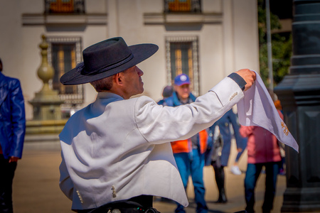 SANTIAGO, CHILE - SEPTEMBER 13, 2018: Outdoor view of unidentified man wearing boots, white t-shirt, black hat and black pants dancing in Armas square in Santiago, Chileのeditorial素材