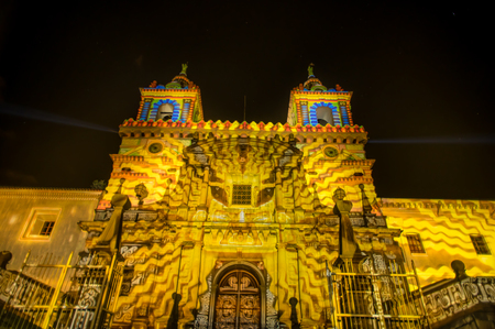 QUITO, ECUADOR- AUGUST, 15, 2018: Crowd admiring the spectacle of lights projected on the facade of San francisco church, festival of light takes place every August in Quitoのeditorial素材