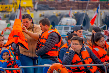 VALPARAISO, CHILE - SEPTEMBER, 15, 2018: Outdoor view of unidentified tourists wearing a life jacket inside of a tourist boat in Port of Valparaiso on the Pacific Coastのeditorial素材