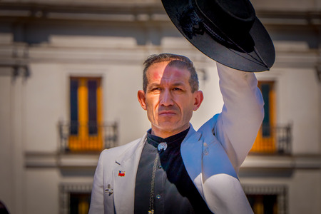 SANTIAGO, CHILE - SEPTEMBER 13, 2018: Unidentified man wearing jacket and holding a black hat in his hand in Armas square in Santiagoのeditorial素材