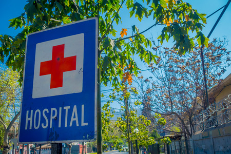 SANTIAGO, CHILE - SEPTEMBER 13, 2018: Close up of informative sign of red cross in metallic structure of Hospital close, located in the city of Santiagoのeditorial素材