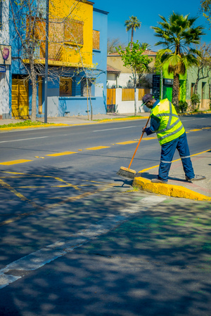 SANTIAGO, CHILE - SEPTEMBER 17, 2018: Outdoor view of unidentified man wearing uniform and sweeping the streets in dowtown of the city of Santiagoのeditorial素材